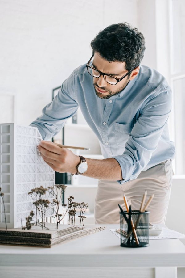 handsome-architect-working-with-architecture-model-on-table-in-office-1.jpg